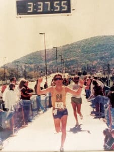 Stephen Loney finishing a marathon decades ago.